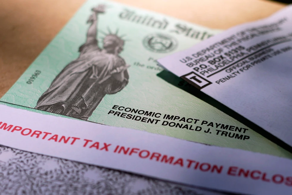 A stack of cash next to a checkbook