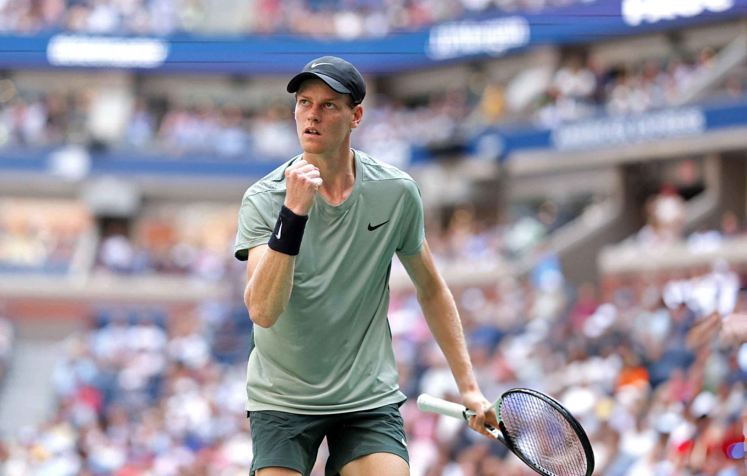 Jannik Sinner holding a tennis racket